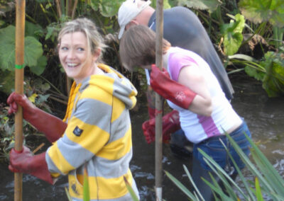 Woman smiling stood in river